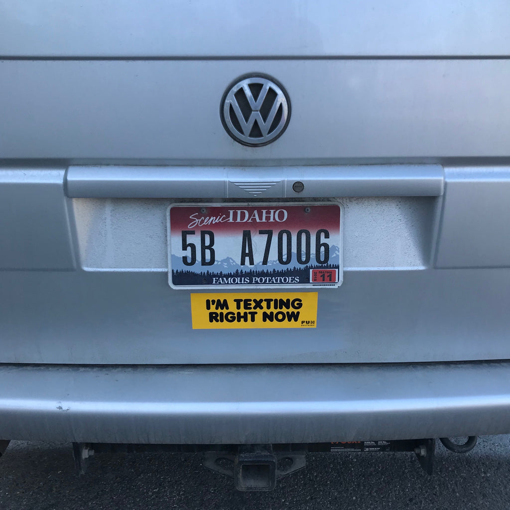 I'm texting right now prank bumper sticker displayed on Volkswagen trunk