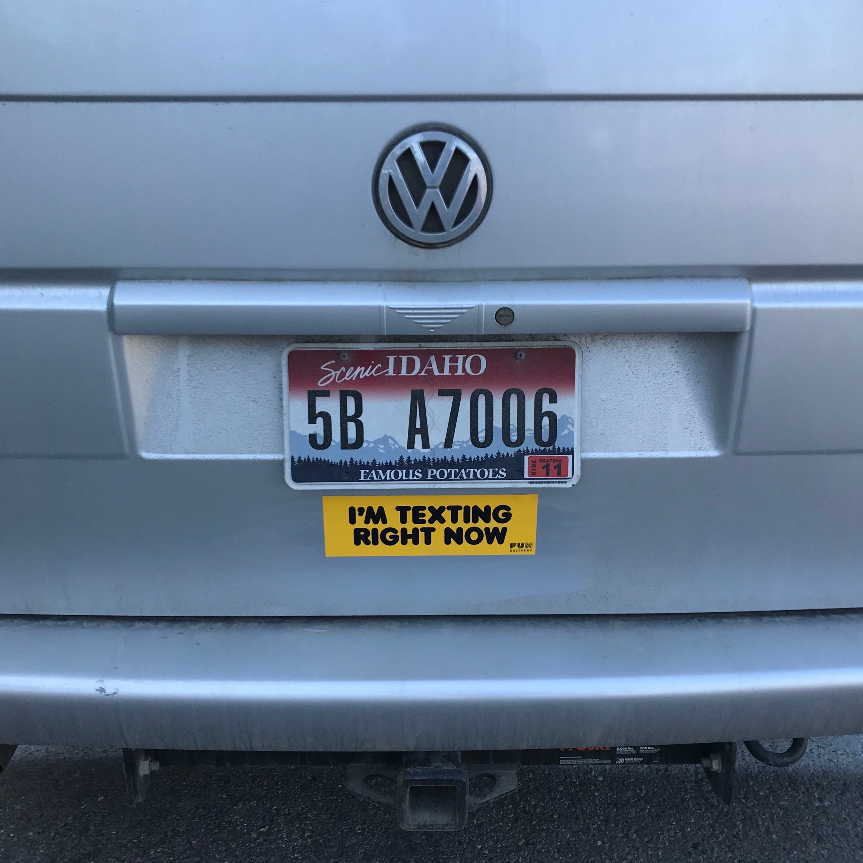I'm texting right now prank bumper sticker displayed on Volkswagen trunk
